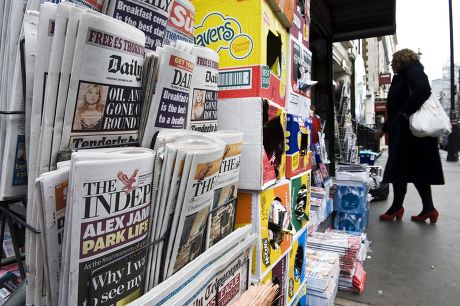 British citizens reading newspapers London street